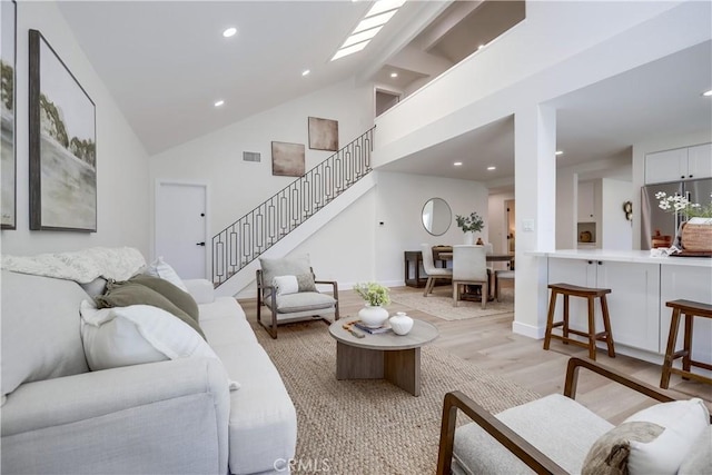 14632 Kimberly Cir, Tustin, CA 92780 - living room featuring stairway, light wood-type flooring, high vaulted ceiling, and recessed lighting