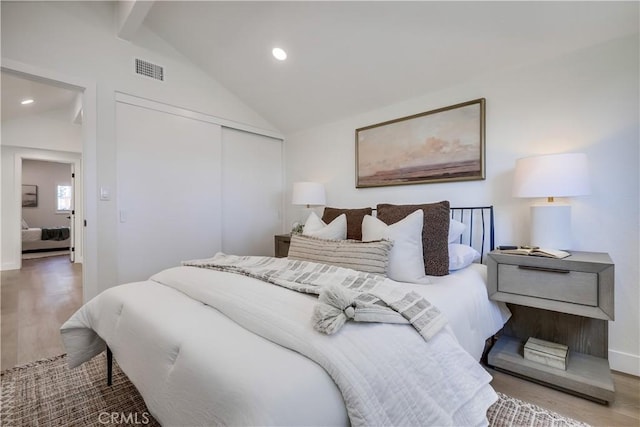 14632 Kimberly Cir, Tustin, CA 92780 - bedroom with lofted ceiling, a closet, wood finished floors, and recessed lighting