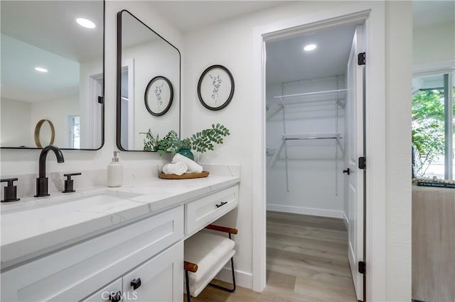 14632 Kimberly Cir, Tustin, CA 92780 - bathroom featuring vanity, wood finished floors, recessed lighting, and a spacious closet