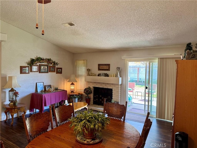 512 E Clinton Ave, Atwater, CA 95301 - dining area featuring a textured ceiling, wood finished floors, lofted ceiling, and a fireplace