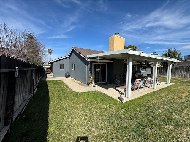 512 E Clinton Ave, Atwater, CA 95301 - back of property featuring a chimney, stucco siding, a fenced backyard, ceiling fan, and a patio