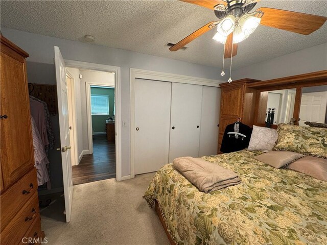 512 E Clinton Ave, Atwater, CA 95301 - bedroom with a closet, light colored carpet, a textured ceiling, and ceiling fan