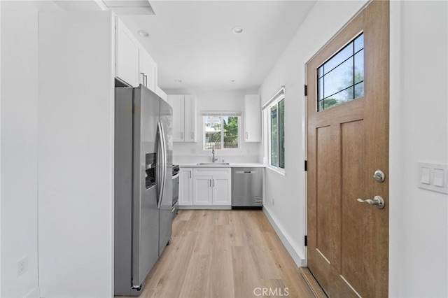 18656 Runnymede St, Reseda, CA 91335 - kitchen featuring appliances with stainless steel finishes, white cabinetry, light wood finished floors, light countertops, and recessed lighting