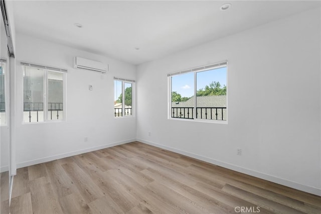 18656 Runnymede St, Reseda, CA 91335 - unfurnished room with a wall unit AC, light wood-type flooring, and recessed lighting