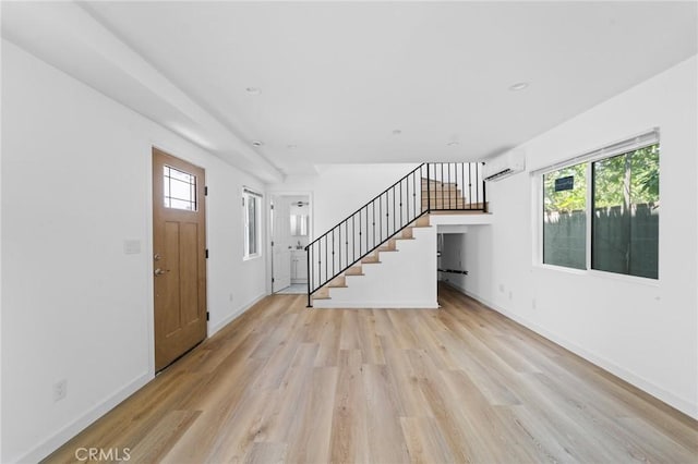 18656 Runnymede St, Reseda, CA 91335 - entrance foyer featuring a wall mounted air conditioner, stairway, light wood-type flooring, and plenty of natural light