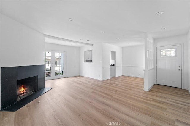 18656 Runnymede St, Reseda, CA 91335 - unfurnished living room with healthy amount of natural light, a warm lit fireplace, light wood-style flooring, and recessed lighting