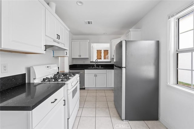 18656 Runnymede St, Reseda, CA 91335 - kitchen featuring freestanding refrigerator, under cabinet range hood, gas range gas stove, white cabinetry, and dark countertops