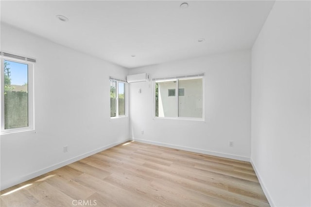 18656 Runnymede St, Reseda, CA 91335 - spare room with light wood-style flooring and a wall unit AC