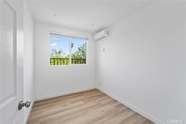 18656 Runnymede St, Reseda, CA 91335 - empty room with an AC wall unit and light wood-style flooring