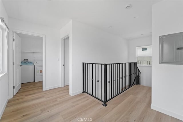 18656 Runnymede St, Reseda, CA 91335 - hall featuring an upstairs landing, electric panel, wood finished floors, and washer and clothes dryer