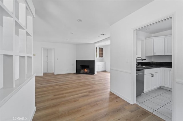 18656 Runnymede St, Reseda, CA 91335 - unfurnished living room with light wood-style flooring and a fireplace with flush hearth