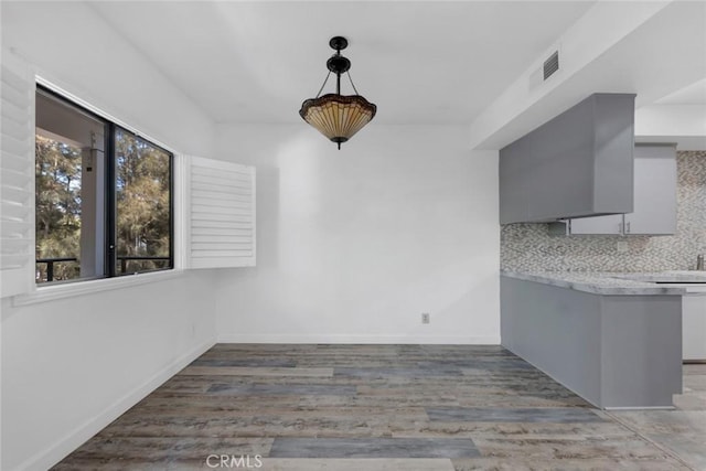 13331 Moorpark St Unit 206, Sherman Oaks, CA 91423 - unfurnished dining area featuring healthy amount of natural light and light wood-style floors