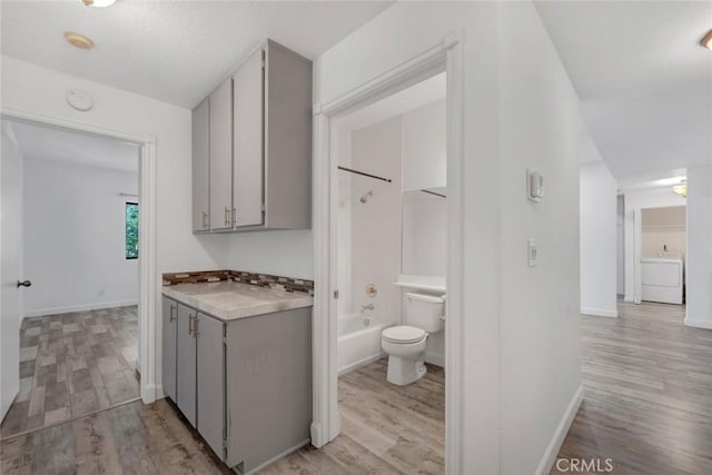 13331 Moorpark St Unit 206, Sherman Oaks, CA 91423 - hall with washer / dryer and light wood-style floors