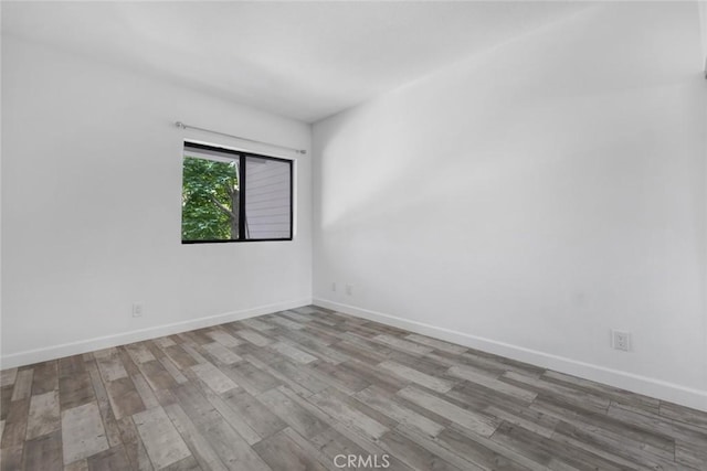 13331 Moorpark St Unit 206, Sherman Oaks, CA 91423 - spare room featuring wood finished floors and baseboards