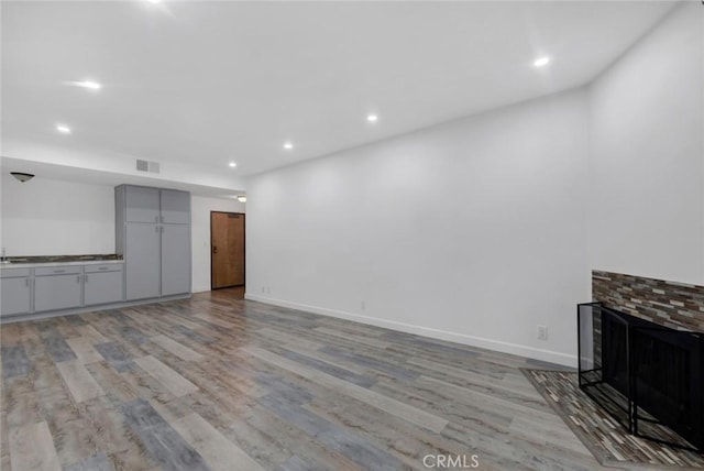 13331 Moorpark St Unit 206, Sherman Oaks, CA 91423 - unfurnished living room with light wood-type flooring, recessed lighting, and a fireplace