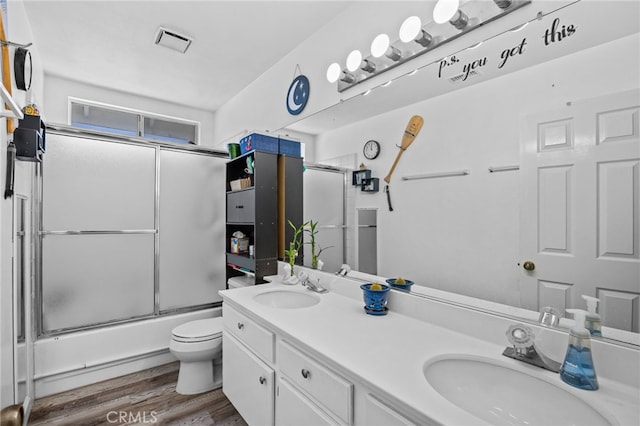 3681 Foxplain Rd, Corona, CA 92882 - full bathroom featuring double vanity, combined bath / shower with glass door, and wood finished floors