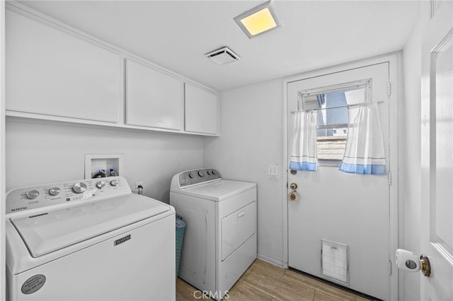 3681 Foxplain Rd, Corona, CA 92882 - laundry room with separate washer and dryer, cabinet space, and light wood-type flooring