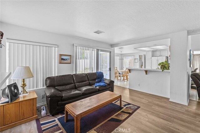 3681 Foxplain Rd, Corona, CA 92882 - living area with wood finished floors and a textured ceiling