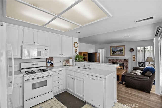 3681 Foxplain Rd, Corona, CA 92882 - kitchen with white appliances, a peninsula, and white cabinetry