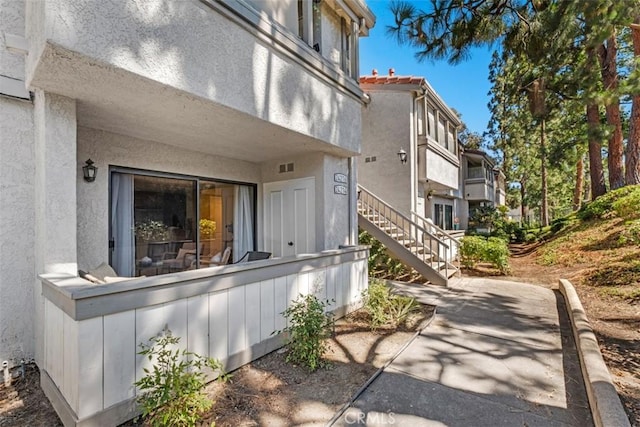 2421473 El Pilar, Laguna Niguel, CA 92677 - view of side of property with a patio area, stairway, and stucco siding