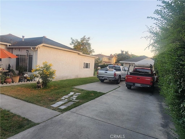 12138 Magnolia St, El Monte, CA 91732 - property exterior at dusk featuring stucco siding, driveway, and a lawn