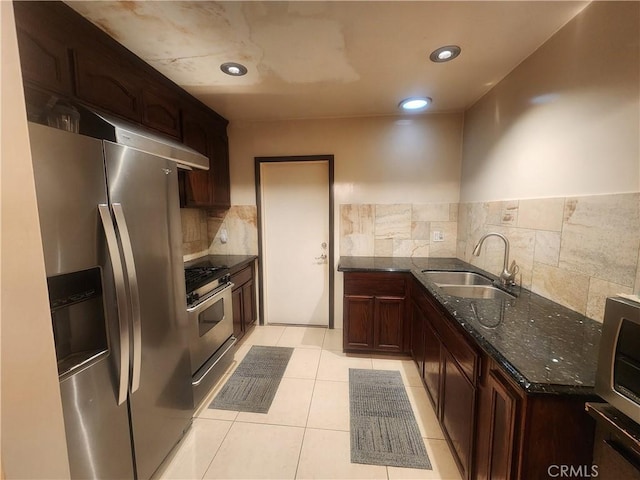 12138 Magnolia St, El Monte, CA 91732 - kitchen with appliances with stainless steel finishes, dark stone counters, tasteful backsplash, light tile patterned floors, and recessed lighting