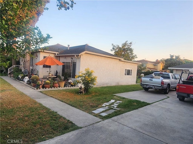 12138 Magnolia St, El Monte, CA 91732 - view of side of property featuring stucco siding, a yard, and driveway