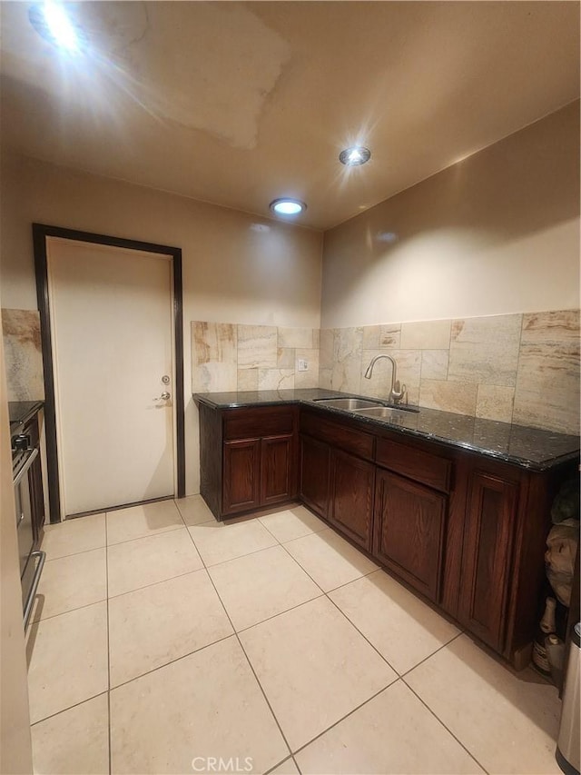 12138 Magnolia St, El Monte, CA 91732 - kitchen featuring dark stone countertops, light tile patterned flooring, and recessed lighting