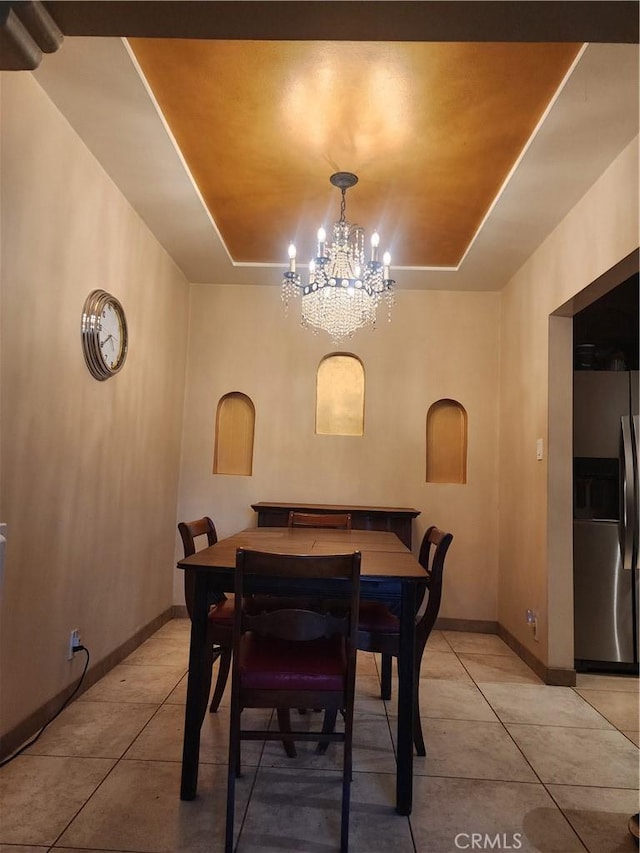 12138 Magnolia St, El Monte, CA 91732 - dining room featuring a raised ceiling, light tile patterned floors, and a chandelier
