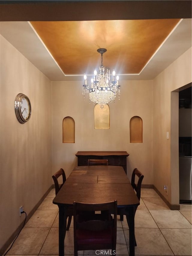 12138 Magnolia St, El Monte, CA 91732 - dining room with a tray ceiling, light tile patterned floors, and a chandelier