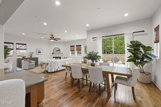 5000 Terramar Way, Oxnard, CA 93035 - dining room with recessed lighting, a warm lit fireplace, plenty of natural light, wood finished floors, and ceiling fan