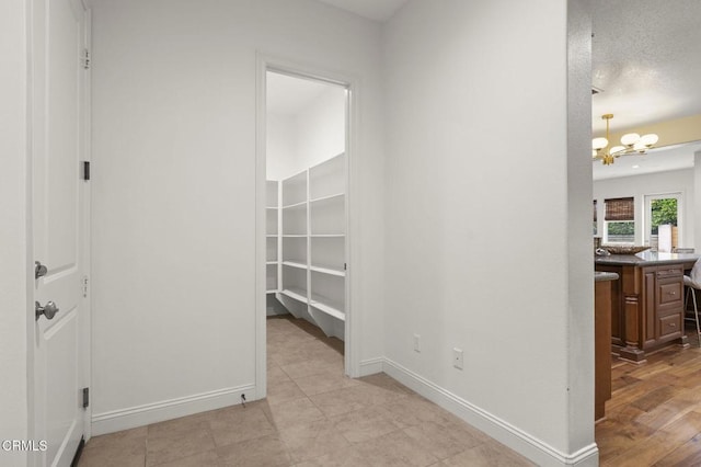 5000 Terramar Way, Oxnard, CA 93035 - hallway with a chandelier and baseboards