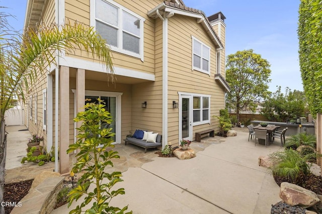 5000 Terramar Way, Oxnard, CA 93035 - rear view of property featuring a patio area, a chimney, and outdoor dining space
