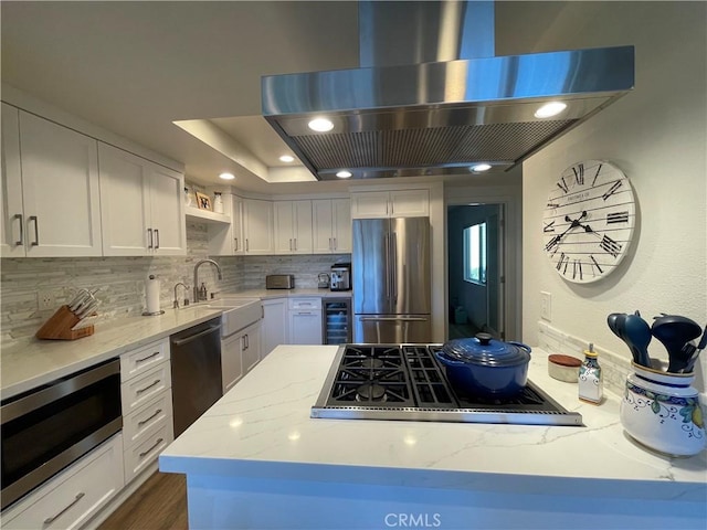 1158 S Westlake Blvd Unit D, Westlake Village, CA 91361 - kitchen with ventilation hood, stainless steel appliances, decorative backsplash, white cabinets, and light stone counters