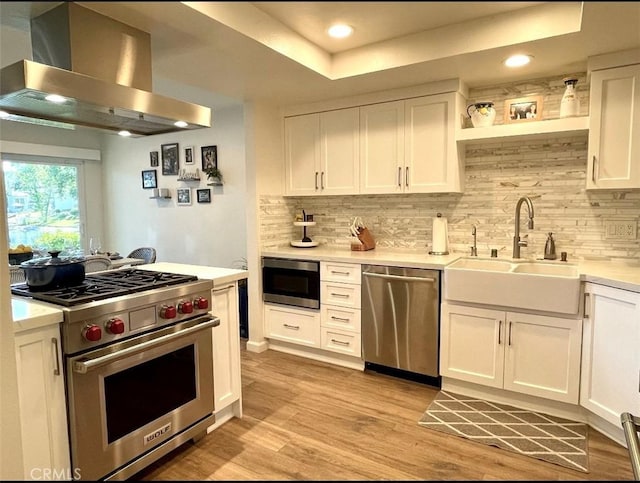 1158 S Westlake Blvd Unit D, Westlake Village, CA 91361 - kitchen featuring appliances with stainless steel finishes, wall chimney range hood, light countertops, white cabinets, and recessed lighting