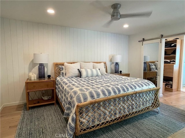 1158 S Westlake Blvd Unit D, Westlake Village, CA 91361 - bedroom with wood finished floors, a barn door, ceiling fan, wood walls, and recessed lighting