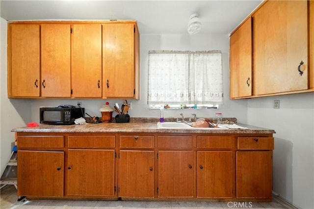 138 Banbridge Ave, La Puente, CA 91744 - kitchen with black microwave and brown cabinetry