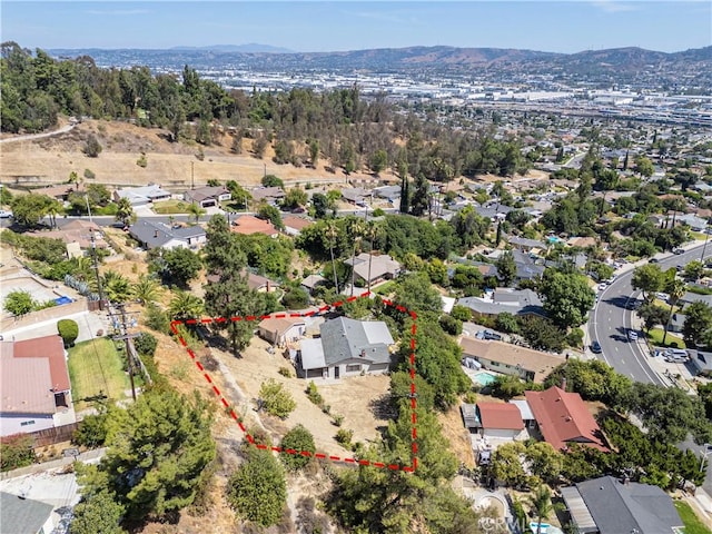 138 Banbridge Ave, La Puente, CA 91744 - aerial perspective of suburban area with property parcel outlined and mountains