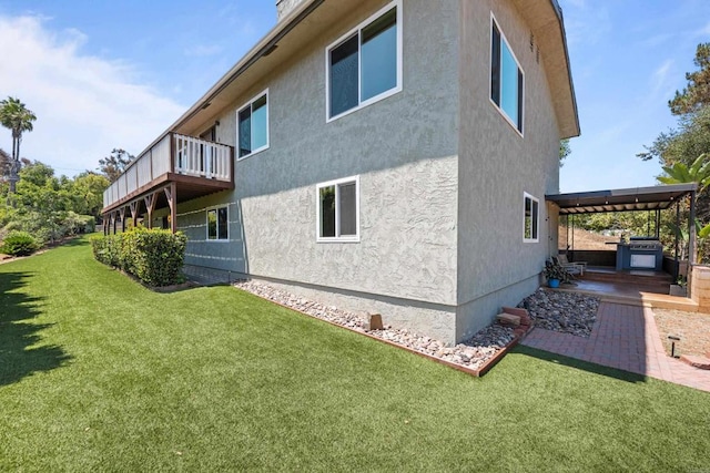 1026 Eucalyptus Ave, Vista, CA 92084 - rear view of house with stucco siding, a lawn, and a patio