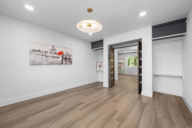 1026 Eucalyptus Ave, Vista, CA 92084 - unfurnished bedroom with wood finished floors, recessed lighting, and two closets