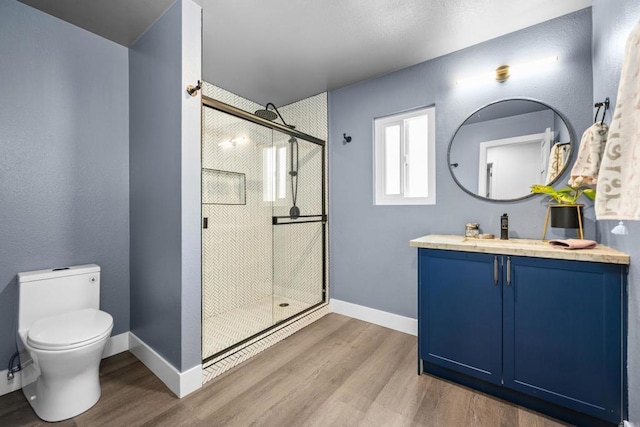 1026 Eucalyptus Ave, Vista, CA 92084 - full bathroom featuring wood finished floors, a stall shower, and vanity