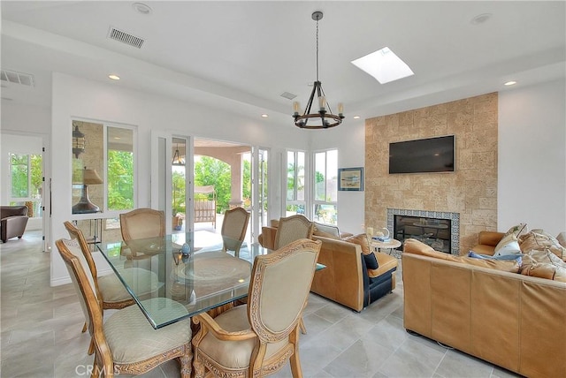6236 Ashton Pl, Rancho Cucamonga, CA 91739 - dining space featuring a chandelier, recessed lighting, a fireplace, a skylight, and light tile patterned floors