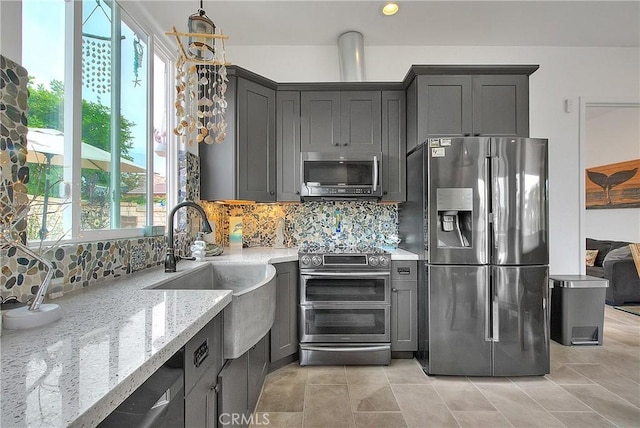 6236 Ashton Pl, Rancho Cucamonga, CA 91739 - kitchen with stainless steel appliances, light stone countertops, tasteful backsplash, gray cabinets, and light tile patterned flooring