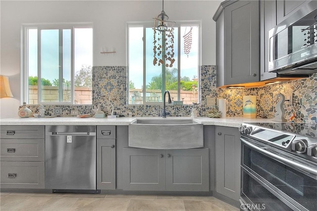 6236 Ashton Pl, Rancho Cucamonga, CA 91739 - kitchen with appliances with stainless steel finishes, gray cabinets, plenty of natural light, and tasteful backsplash
