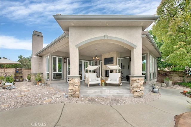 6236 Ashton Pl, Rancho Cucamonga, CA 91739 - rear view of house featuring stucco siding and a chimney