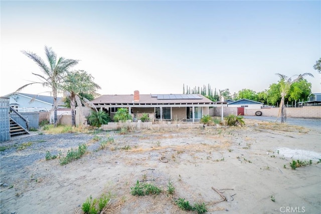 11220 Puente Way, Jurupa Valley, CA 91752 - back of property featuring roof mounted solar panels and a porch