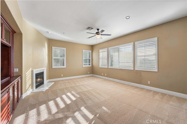 37351 Paintbrush Dr, Palmdale, CA 93551 - unfurnished living room featuring ceiling fan, light colored carpet, and a glass covered fireplace