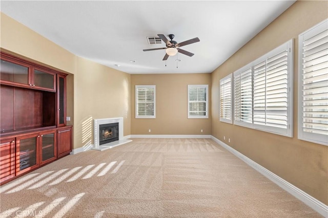 37351 Paintbrush Dr, Palmdale, CA 93551 - unfurnished living room with ceiling fan, a glass covered fireplace, and carpet flooring