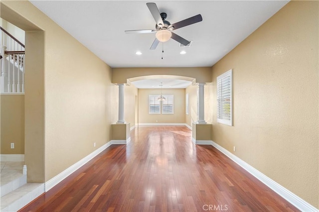 37351 Paintbrush Dr, Palmdale, CA 93551 - hallway with ornate columns, arched walkways, wood finished floors, and recessed lighting