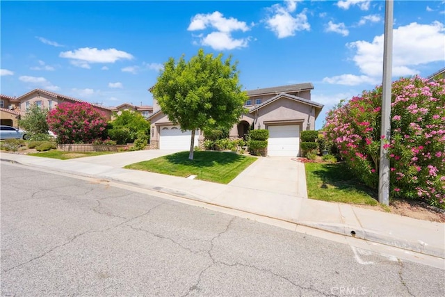 37351 Paintbrush Dr, Palmdale, CA 93551 - view of property hidden behind natural elements featuring driveway, stucco siding, a front yard, and an attached garage